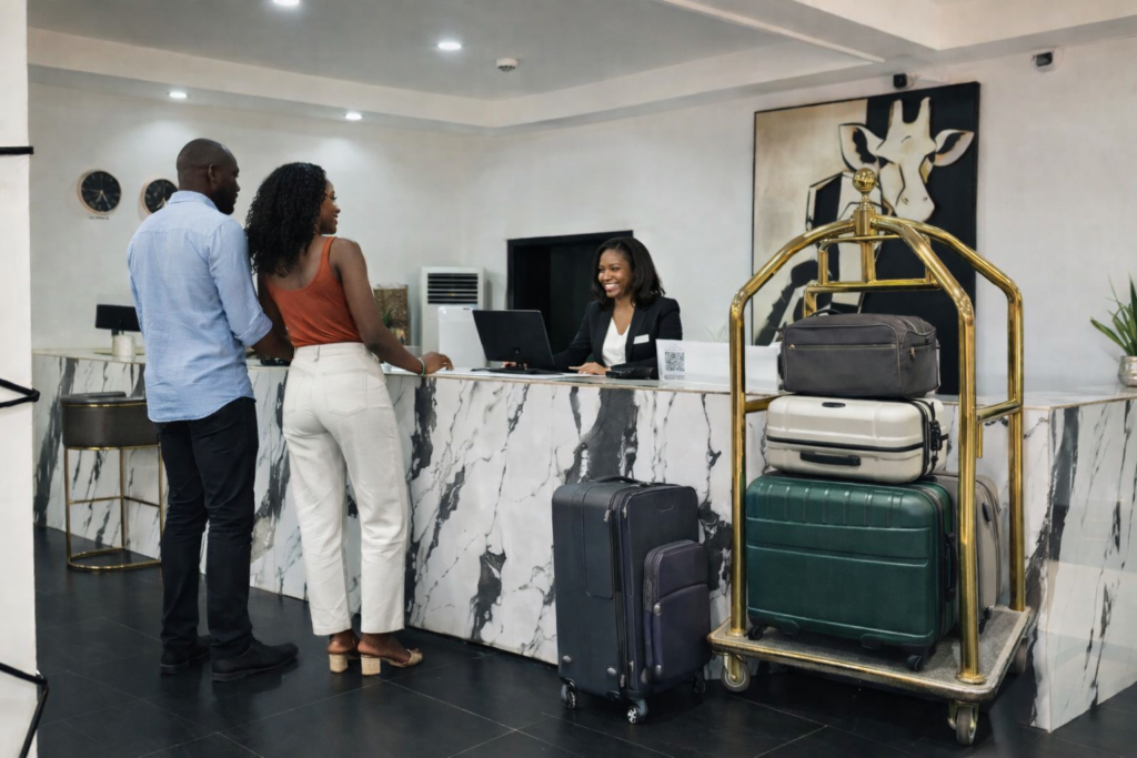 Couple checking in at MUSE Boutique Hotel Enugu with attentive front desk staff providing 24-7 guest service and seamless hospitality experience